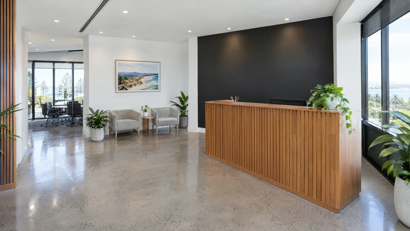 A freshly painted modern office reception with a charcoal feature wall