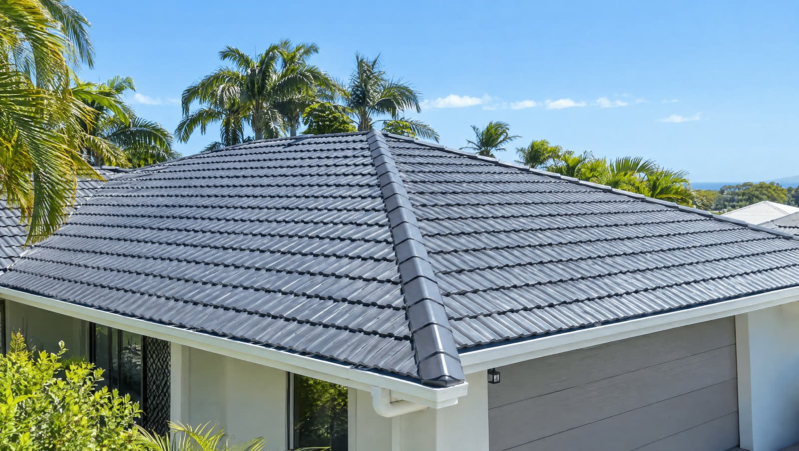A freshly coated charcoal tile roof on a Sunshine Coast home